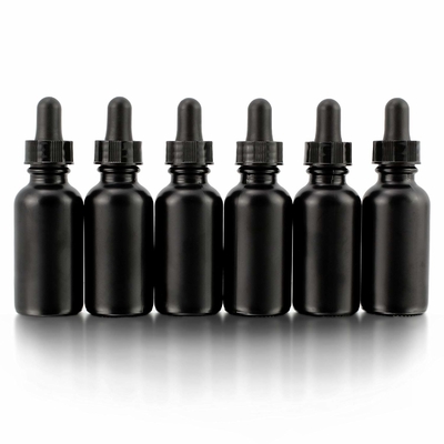 A garrafa de vidro preta do olho 30ml cosmético com conta-gotas derrama não